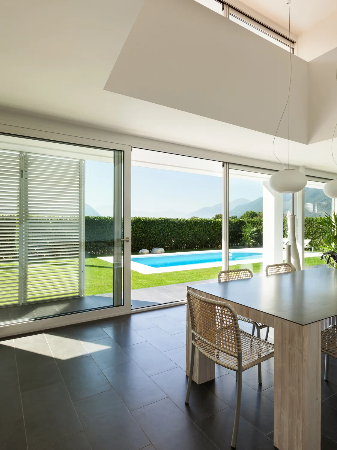 Modern villa interior with radiant floor cooling opening onto a pool terrace